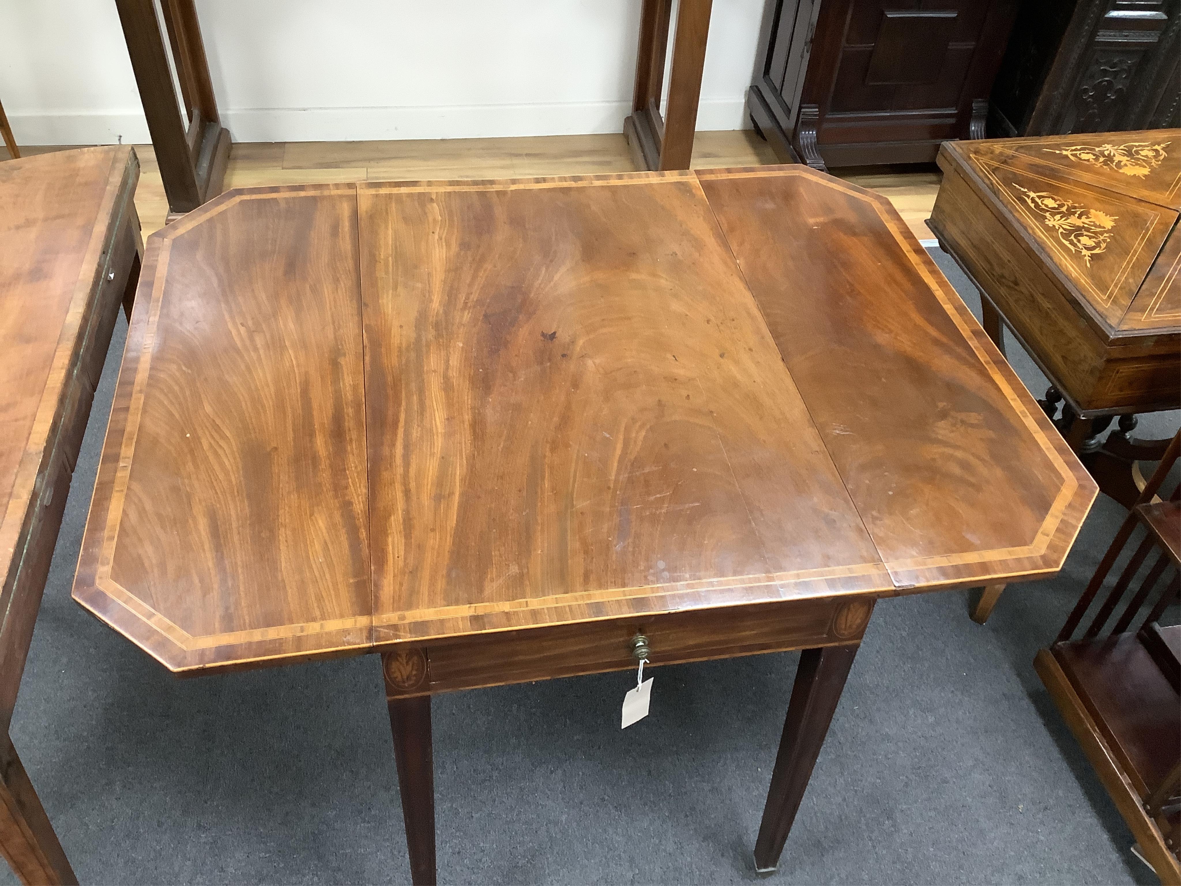 A George III crossbanded mahogany Pembroke table, with canted rectangular flaps and frieze drawer, on moulded squared tapered legs, fitted brass castors, 84cm wide, 54cm deep, 72cm high. Condition - overall of a slightly